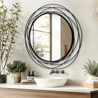 STEELVIEW runder Wandspiegel mit schwarzem Metallrahmen über einem Waschtisch